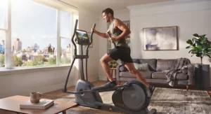 An athlete training on a quiet elliptical machine for apartment living room fitness.