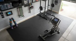 Top-down view of an efficient garage gym layout featuring a heavy duty elliptical and free weights.